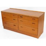 A 1960's Lucas teak side cabinet, set with two banks of three drawers, on a block base, 67cm high, 1
