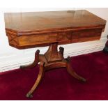A Regency rosewood and brass inlaid fold over card table, raised on a waisted square column, over a