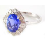 An oval tanzanite and diamond dress ring, the oval tanzanite totalling approx 3.12cts overall, surro