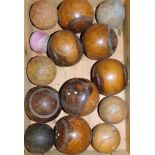 Various lignum vitae bowls, and four croquet balls, etc, in a wooden crate. (a quantity)