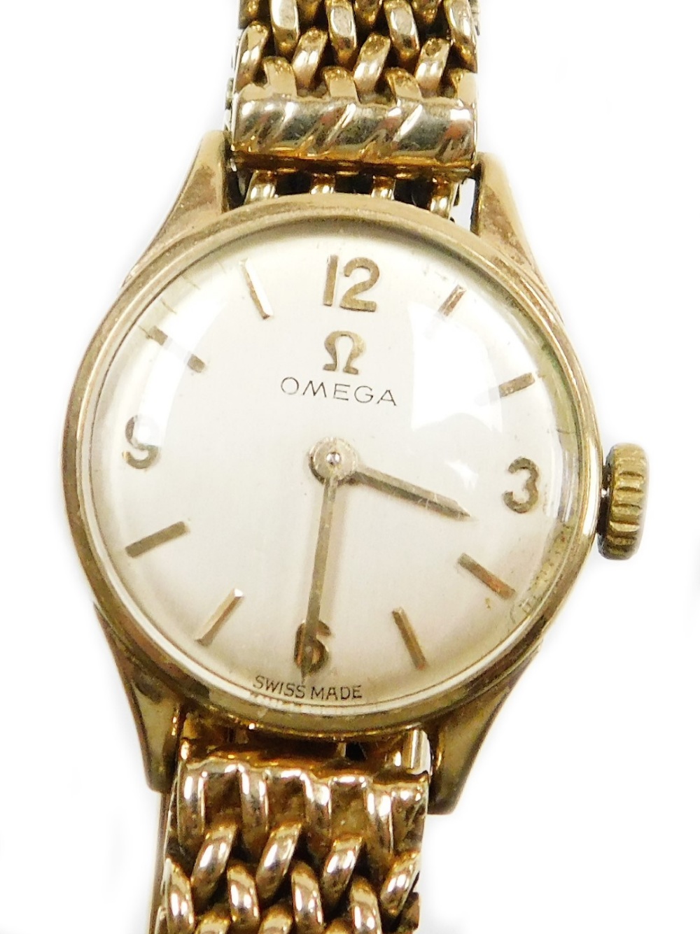 An Omega 9ct gold ladies wristwatch, with small circular silvered dial, 1.2cm diameter, on a four ro