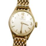 An Omega 9ct gold ladies wristwatch, with small circular silvered dial, 1.2cm diameter, on a four ro