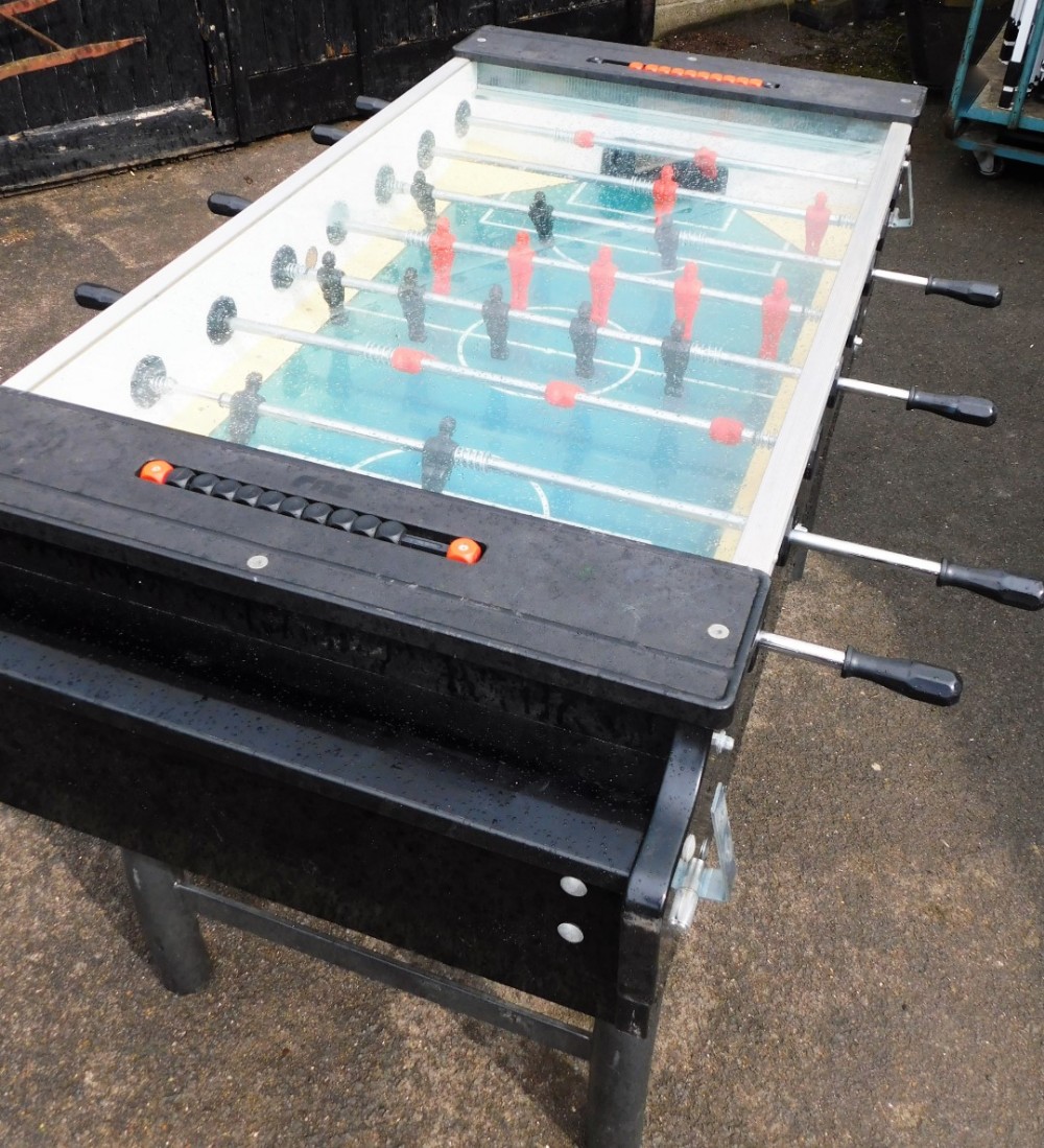 A FAS table football machine, with balls, base, and brackets, 97cm high, 170cm deep, 117cm wide. Not