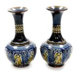A pair of Doulton Lambeth stoneware vases, each with blue, brown and green mottled decoration depict
