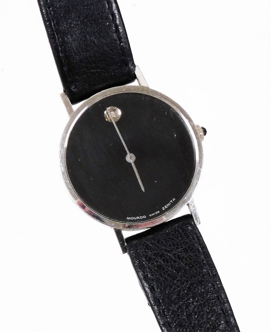 A Movado wristwatch, with circular watch face with blackened dial with tiny diamond set twelve point