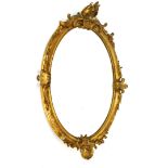A George II style gilt wood oval mirror, oval surmounted by a barogue design shell and scroll and fl