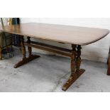 A light beech and elm Ercol dining table, on two splay baluster columns, 73cm high, 176cm wide, 98cm