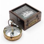 A Captain's cabin map reader compass with magnifying glass, stamped Spencer and Co London 1905, in a