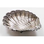 A Victorian silver shell shaped butter dish, heavily repousse decorated with scrolls, flowers and a