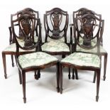 A set of eight George III style mahogany dining chairs, each with a shield back with urn and feather