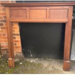 A stained oak fireplace surround,