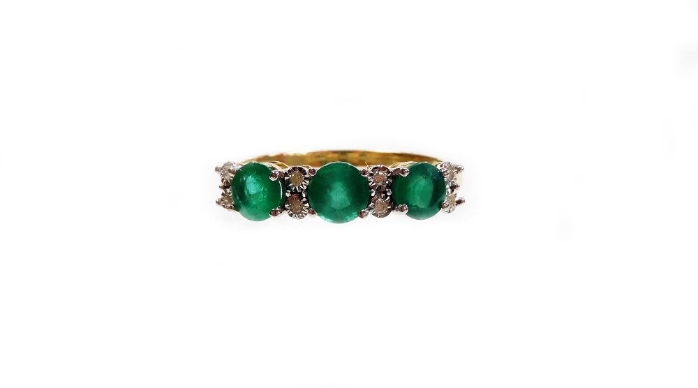 An emerald and diamond dress ring, set with three round emeralds totalling approximately 1.41cts, wi