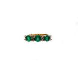 An emerald and diamond dress ring, set with three round emeralds totalling approximately 1.41cts, wi