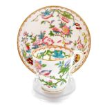 A Minton cup and saucer, profusely decorated with flowers birds and vines, marked English porcelain
