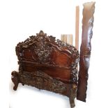 A French design heavily carved mahogany single bed frame, the carvings of flowers and leaves, with h