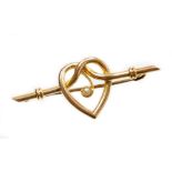 A heart shaped bar brooch, the central heart section with single applied seed pearl, on a ribbed bar