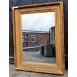 A rectangular gilt framed wall mirror, with plaster border and moulded leaf and fruit decoration, 15