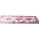 An ivory ground full pile cashmere runner, with floral medallion, 300cm x 180cm.