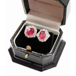 A pair of 18ct white gold ruby and diamond cluster studs, the rubies each treated totalling approxim