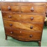 A George III mahogany bow front chest of two short and three long drawers, with fret work marquetry