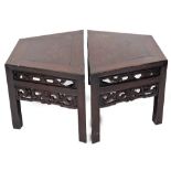 A pair of Chinese hardwood low tables, each with a pierced and carved double frieze, on square secti