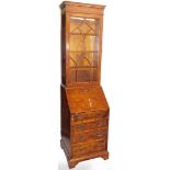 A walnut bureau bookcase, in the Georgian manner, the glazed top with astragal glazed door above a f