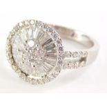 An 18ct white gold diamond cluster dress ring, with round brilliant cut floral cluster centre, surro