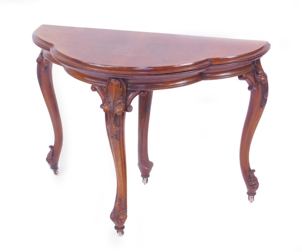 A Victorian figured walnut quatrefoil card table, with folding top having green baize lining, plain