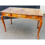 A late 20thC polished oak console table, with glass cover top above three drawers on flared legs, 77