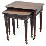 A nest of two 20thC mahogany finish tables, each canted on cylindrical turned reeded graduated legs