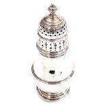 A George V silver sugar castor, the domed pierced lid surmounted by an urn finial, with baluster sha