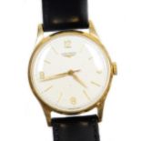 A Longines 9ct gold gentleman's wristwatch, with a cream coloured dial, in a 9ct gold casing, on a l