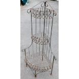 A three tier wrought iron plant stand, 137cm high.