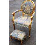 A French style gilt painted bedroom chair, with an oval back, on tapered legs with a blue floral uph