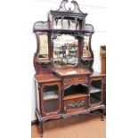 A late Victorian mahogany display cabinet, the upper section with a fixed pierced swan neck pediment