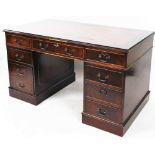 A late 20thC mahogany twin pedestal desk, with red leather gilt inset, and additional glass shelf to