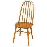 A light elm Ercol style hoop back dining chair, with plain spindles, shaped seat and cylindrical leg