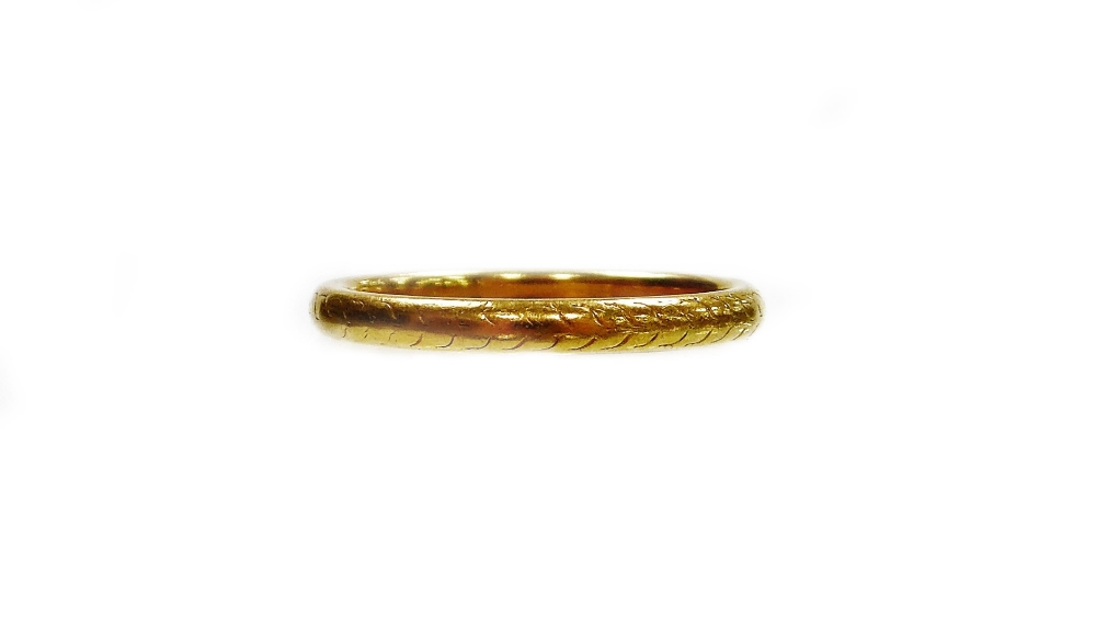 A George V 22ct gold wedding band, with pleated rubbed decoration, Birmingham 1923, ring size N, 3.5