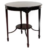 An Edwardian mahogany occasional table, the circular top raised above a carved frieze on square ta