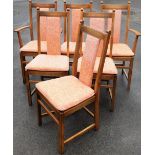 A set of eight light elm Ercol dining chairs, in a light beech and elm with pink floral decoration.