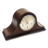 A 1950's oak cased mantel clock, with a silvered coloured dial, and an eight day striking movement,