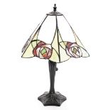 A Tiffany style table lamp, the metal base in the Art Nouveau style, with an eight point rose design