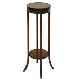 An Edwardian mahogany and boxwood strung plant stand, the circular top centred by a sun patera, on s