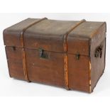 An early 20thC Stork brand pressed leather and wooden bound travel trunk, the domed lid revealing a