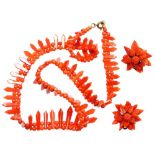 A graduated coral necklace and pair of clip on flower earrings.