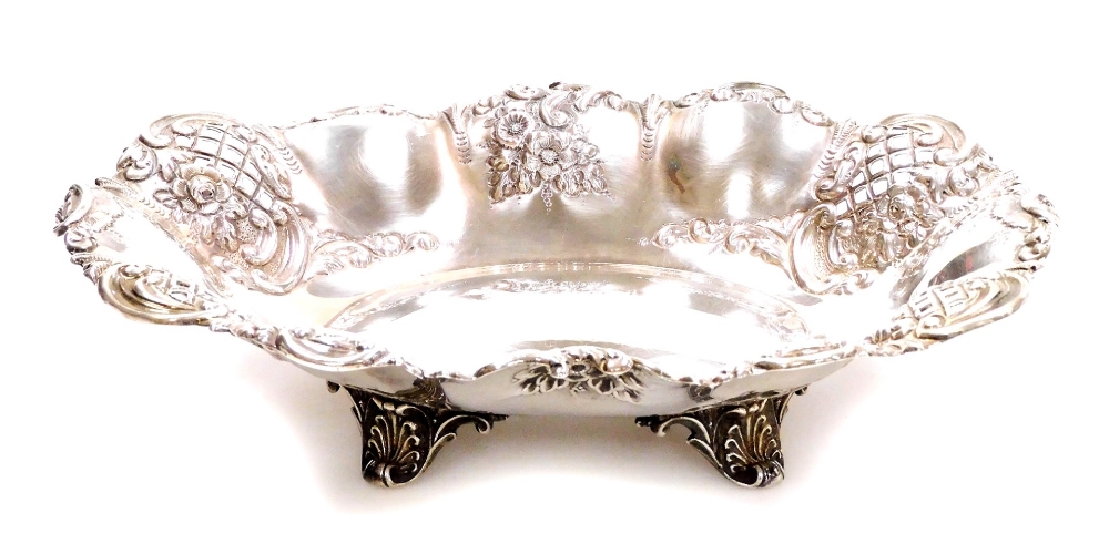 A Victorian silver dish, by Thomas Latham and Earnest Morton, with a scroll border and repousse and