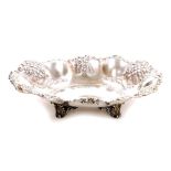 A Victorian silver dish, by Thomas Latham and Earnest Morton, with a scroll border and repousse and