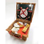 A wicker picnic hamper and contents of various matched part sets.
