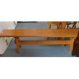 A pine rustic style bench, on tapered supports, 47cm high, 183cm wide, 29cm deep.