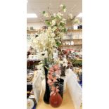 A group of decorative vases and flowers, each with artificial flowers of varying sizes. (a quantity)